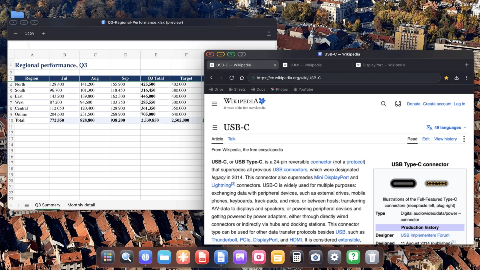 A spreadsheet and a web browser open side by side in separate windows, with a dock along the bottom of an external display.
