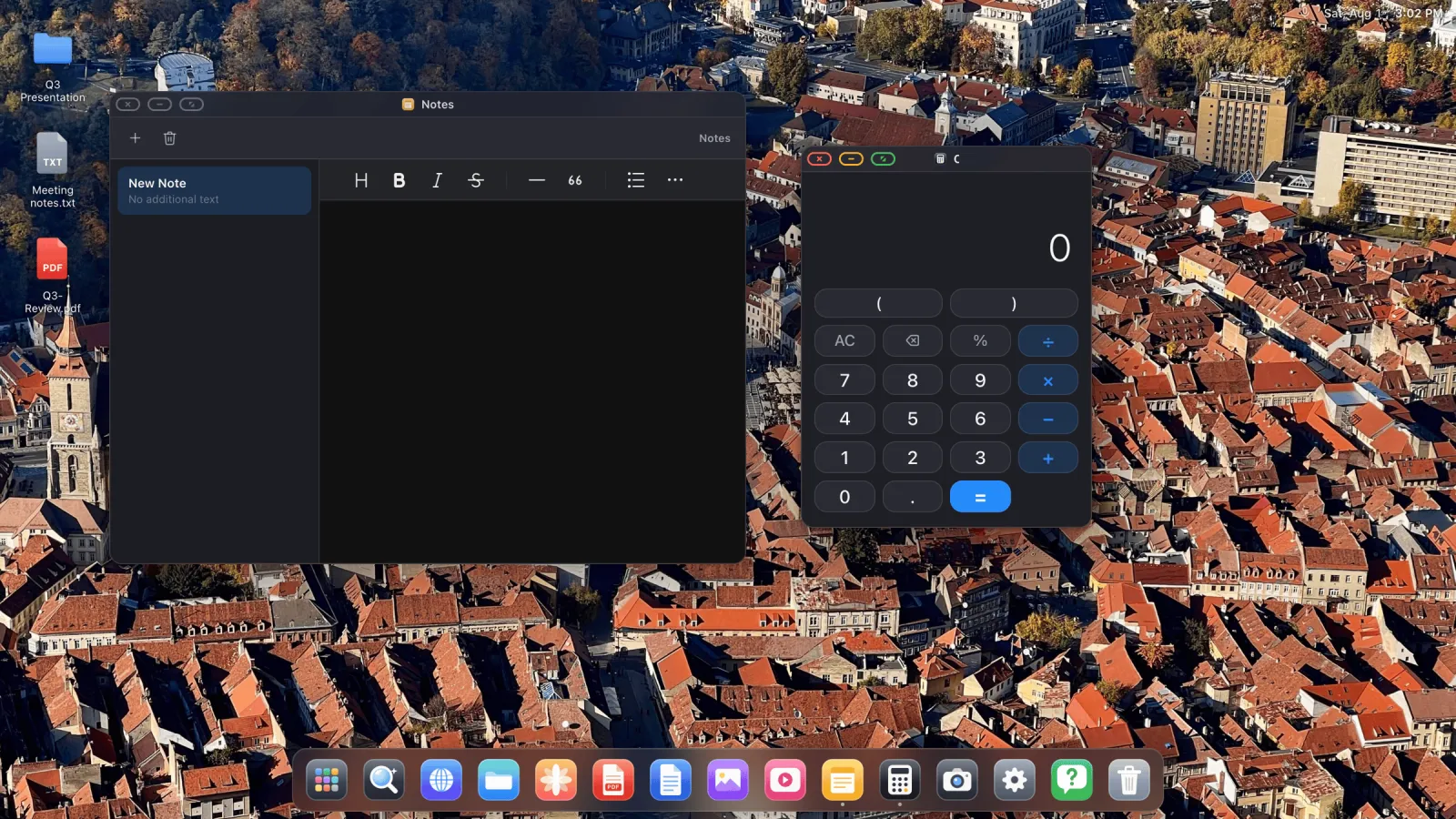 A desktop on an external display with Notes and Calculator open in separate windows above a dock.